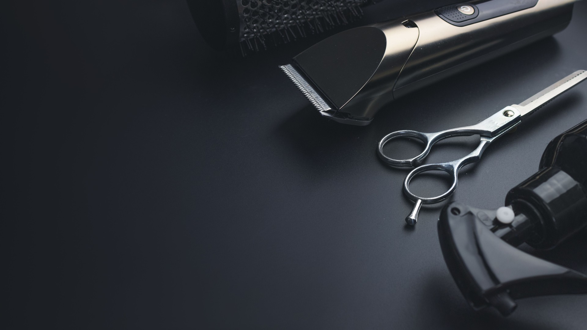 Barbershop concept. Hairdressing tools on dark background top view space for text. Hair extensions, materials and cosmetics, hair care, wig. Hairstyle, haircut in salon.