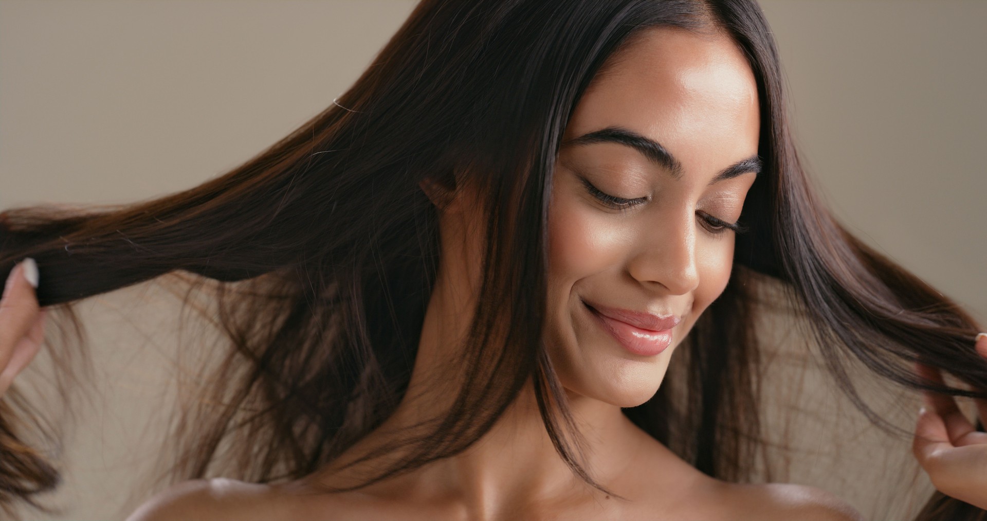 Hair care, smile and woman for beauty, grooming or styling on studio background. Model, shampoo and conditioner results for hairstyle, salon cosmetics and aesthetic for growth or keratin treatment